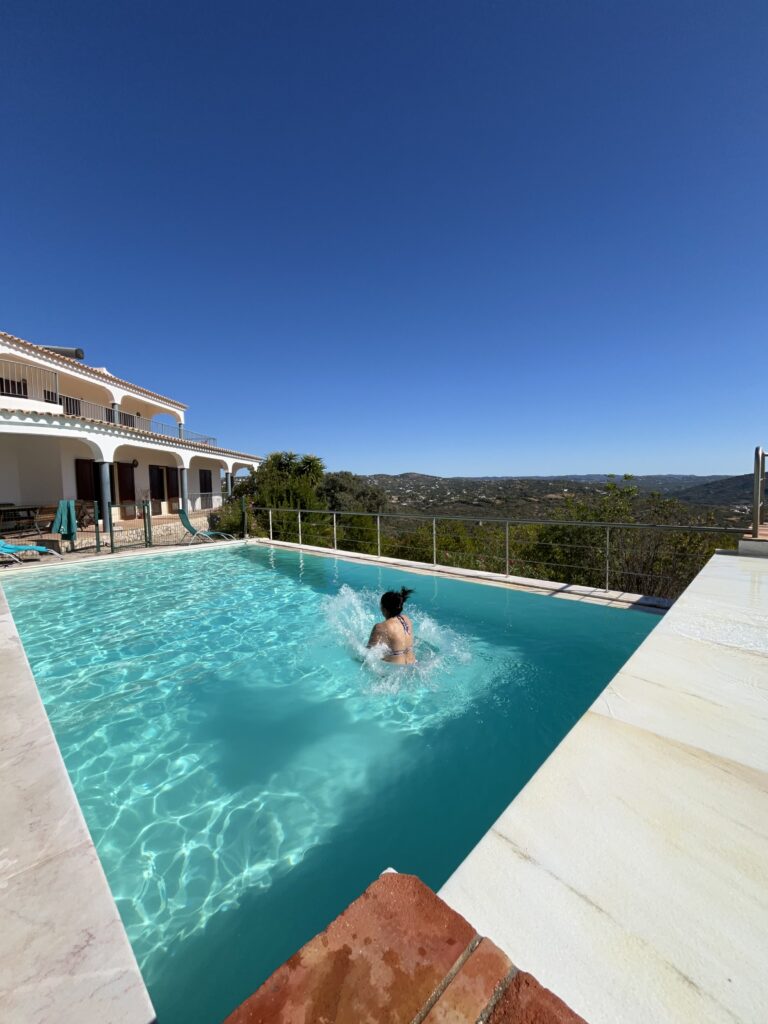 middle aged woman of color jumping into pool at psilocybin retreat