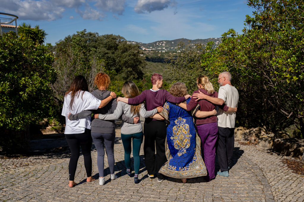 a small group of middle aged adults walking arm in arm at psilocybin mushroom retreat